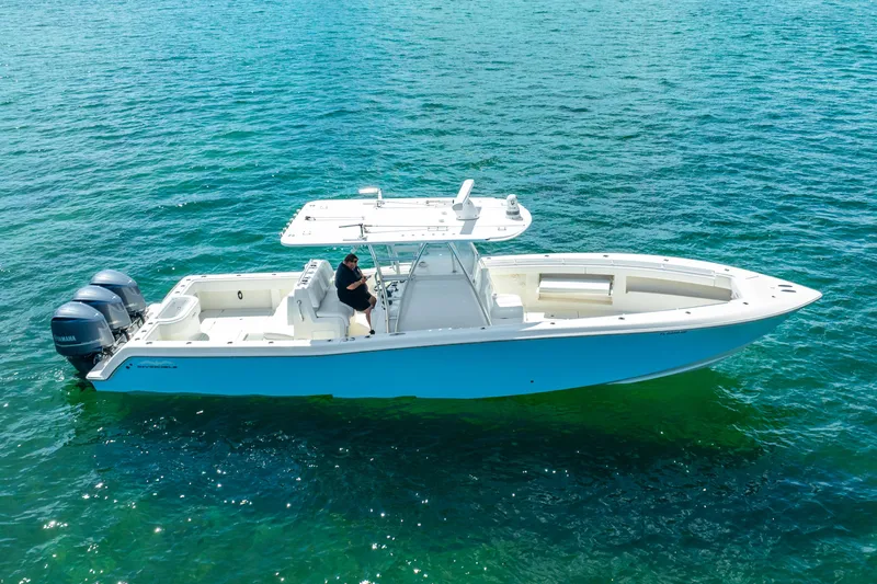  Yacht Photos Pics 2016 Invincible 39 boat on clear blue water, featuring dual outboard engines.