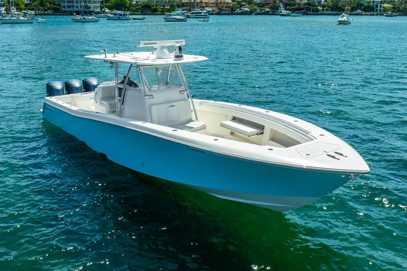  Yacht Photos Pics 2016 Invincible 39 boat on clear blue water with triple outboard engines.