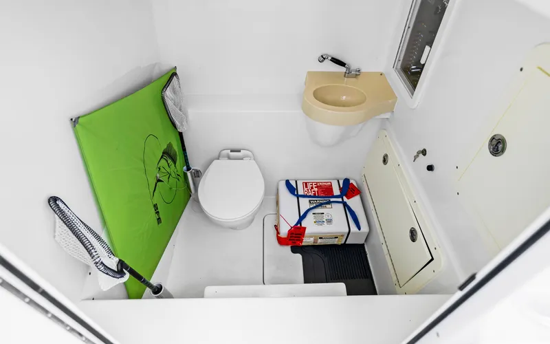  Yacht Photos Pics Compact bathroom in 2016 Invincible 39 boat with toilet, sink, and storage.