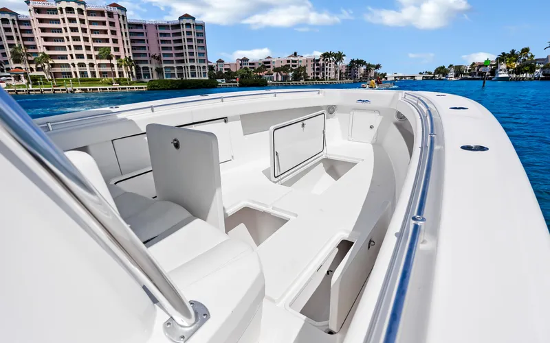 Yacht Photos Pics 2016 Invincible 39 boat with spacious deck, docked near waterfront buildings.