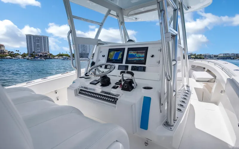  Yacht Photos Pics 2016 Invincible 39 boat cockpit with modern navigation equipment, steering wheel, and ocean view.
