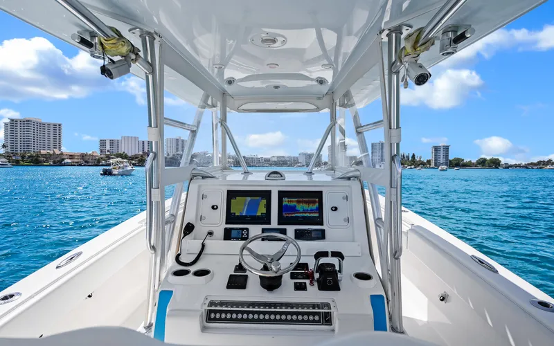  Yacht Photos Pics Center console of 2016 Invincible 39 boat with ocean view and city skyline.