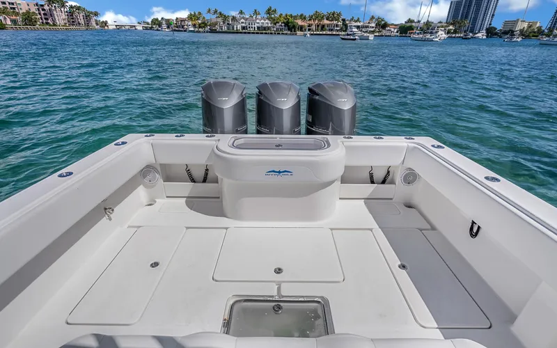  Yacht Photos Pics 2016 Invincible 39 boat deck with triple outboard motors on a sunny day.