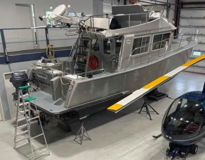  Yacht Photos Pics 2007 Coastal Craft 36 Cruiser in a workshop with a helicopter nearby.