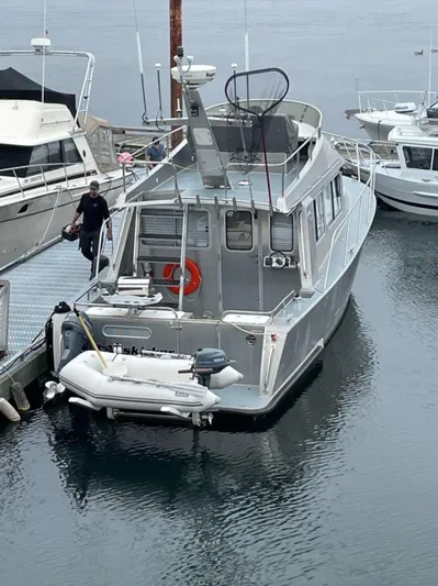  Yacht Photos Pics 2007 Coastal Craft 36 Cruiser docked at marina with inflatable boat attached.