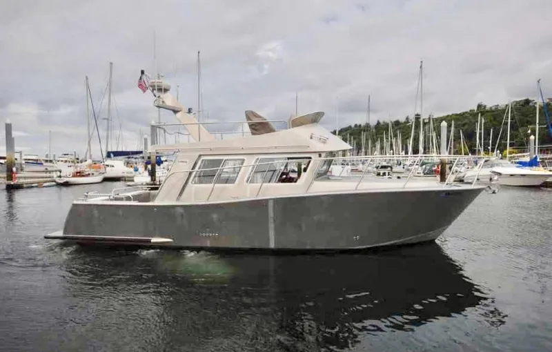  Yacht Photos Pics 2007 Coastal Craft 36 Cruiser yacht docked in marina, surrounded by sailboats.