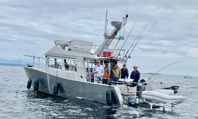  Yacht Photos Pics 2007 Coastal Craft 36 Cruiser with group fishing on open water under cloudy sky.
