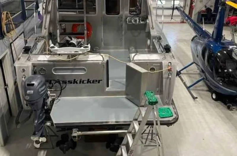  Yacht Photos Pics 2007 Coastal Craft 36 Cruiser in a hangar with a helicopter nearby.