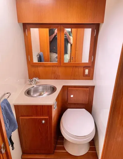  Yacht Photos Pics 2007 Coastal Craft 36 Cruiser bathroom with wood cabinetry, sink, and toilet.