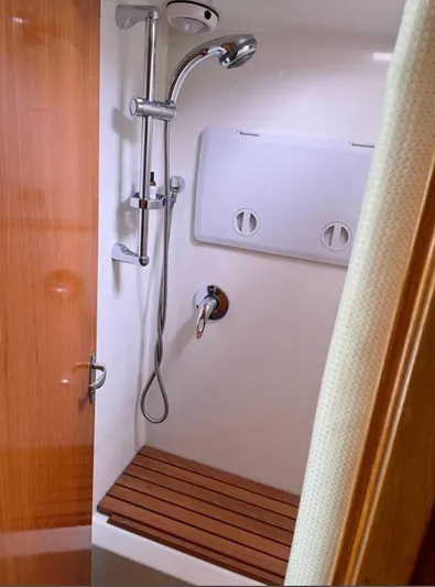  Yacht Photos Pics Shower area in 2007 Coastal Craft 36 Cruiser with wooden bench and modern fixtures.