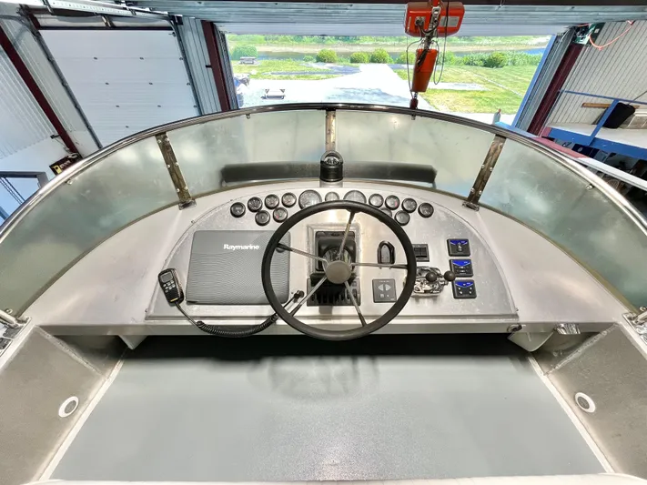  Yacht Photos Pics 2007 Coastal Craft 36 Cruiser helm with steering wheel and control panel.