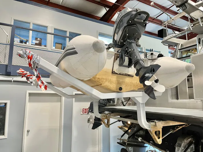  Yacht Photos Pics 2007 Coastal Craft 36 Cruiser with mounted inflatable boat and outboard motor in a storage facility.