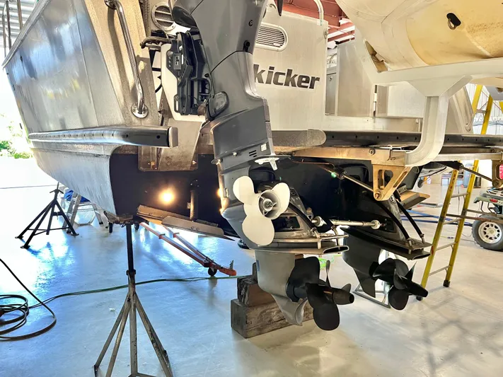  Yacht Photos Pics 2007 Coastal Craft 36 Cruiser undergoing maintenance, showcasing dual outboard motors in a workshop.