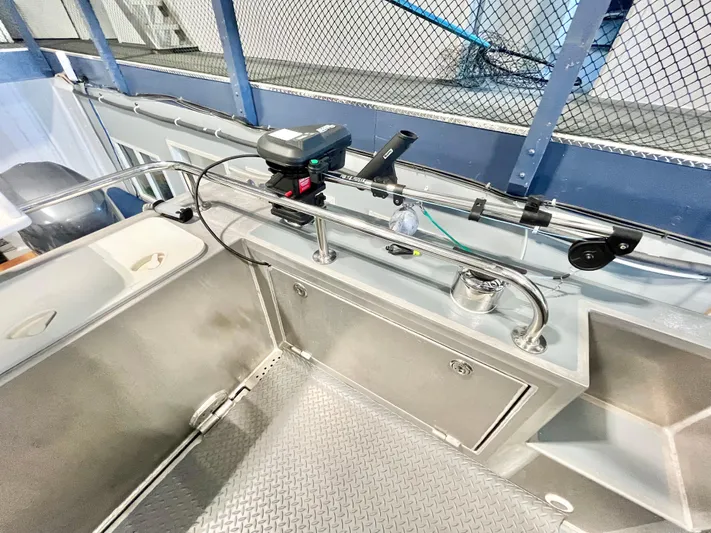  Yacht Photos Pics 2007 Coastal Craft 36 Cruiser deck with fishing equipment and storage compartments.