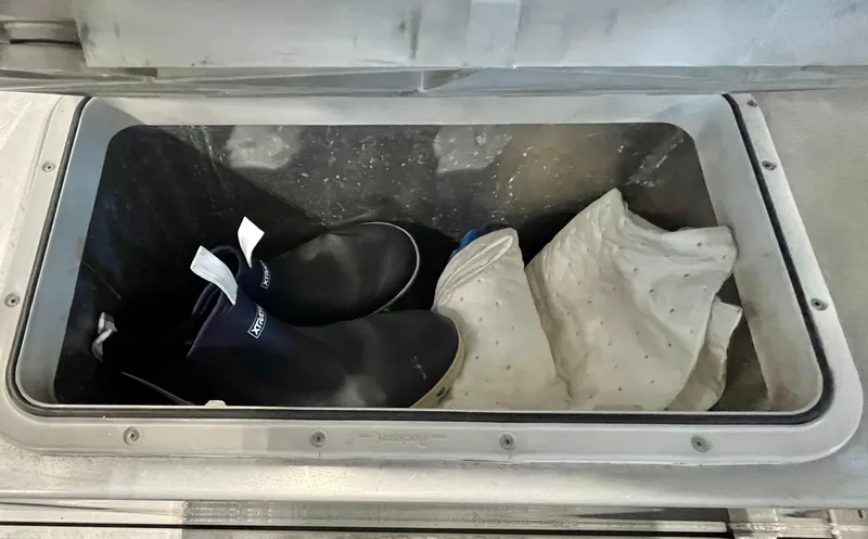  Yacht Photos Pics Storage compartment on 2007 Coastal Craft 36 Cruiser with boots and fabric inside.