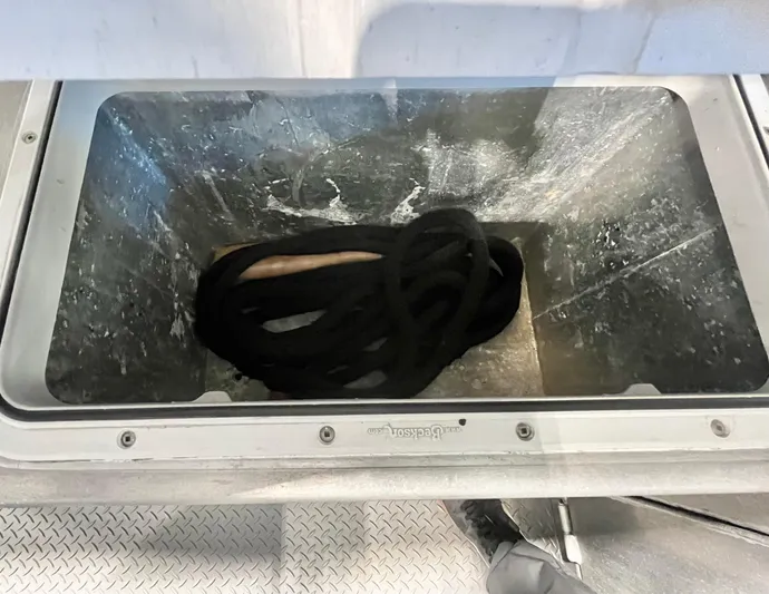  Yacht Photos Pics Storage compartment with black rope on a 2007 Coastal Craft 36 Cruiser boat.