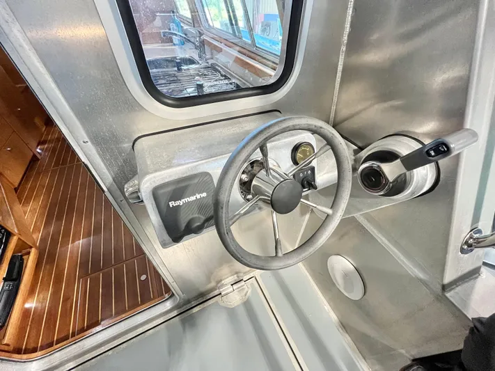  Yacht Photos Pics Steering wheel and controls of a 2007 Coastal Craft 36 Cruiser boat interior.