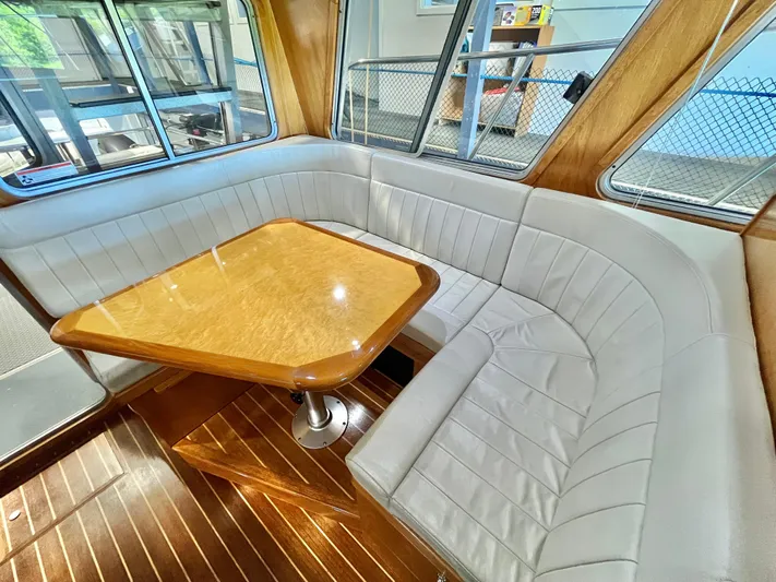  Yacht Photos Pics Luxurious interior of 2007 Coastal Craft 36 Cruiser with elegant wood table and plush seating.
