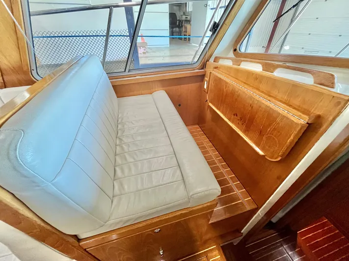  Yacht Photos Pics Interior of 2007 Coastal Craft 36 Cruiser with wooden finish and cushioned seating.