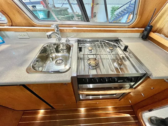  Yacht Photos Pics Compact kitchen in 2007 Coastal Craft 36 Cruiser with stove and sink.
