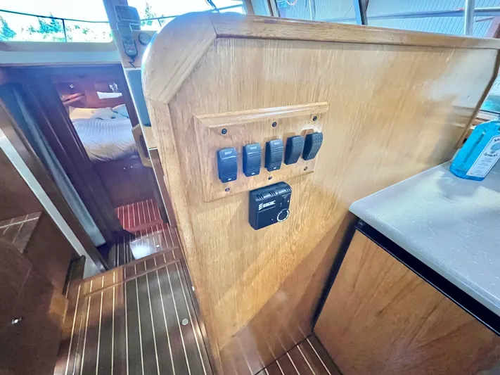  Yacht Photos Pics 2007 Coastal Craft 36 Cruiser interior with wooden paneling and control switches.