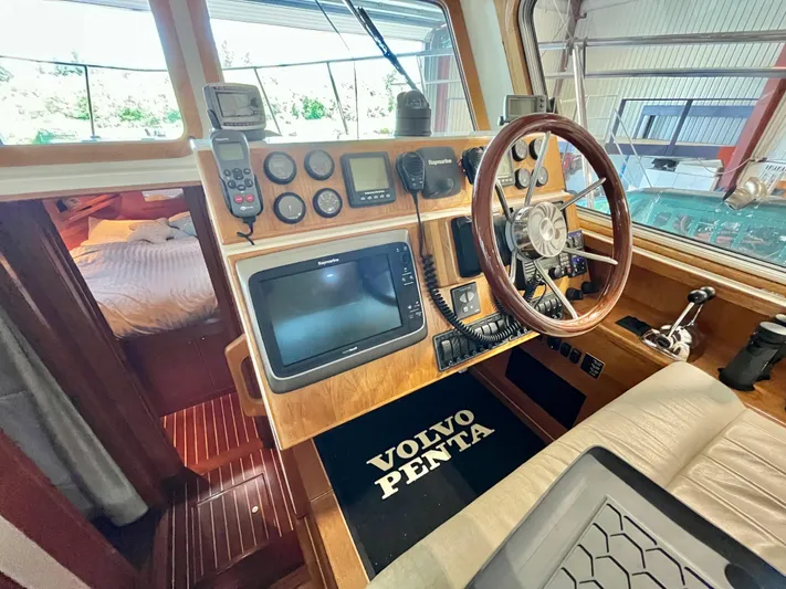  Yacht Photos Pics 2007 Coastal Craft 36 Cruiser helm with navigation equipment and wooden steering wheel.
