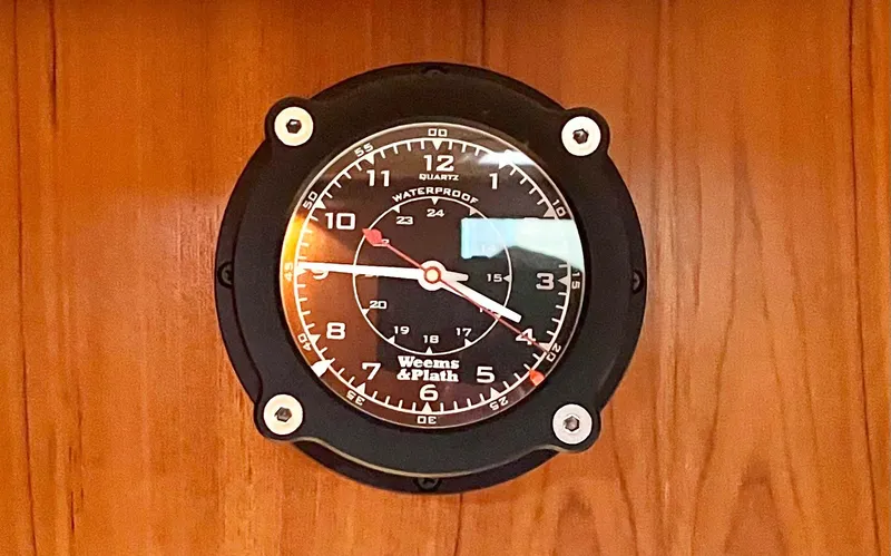  Yacht Photos Pics Wall-mounted nautical clock on 2007 Coastal Craft 36 Cruiser, featuring black face and white numerals.