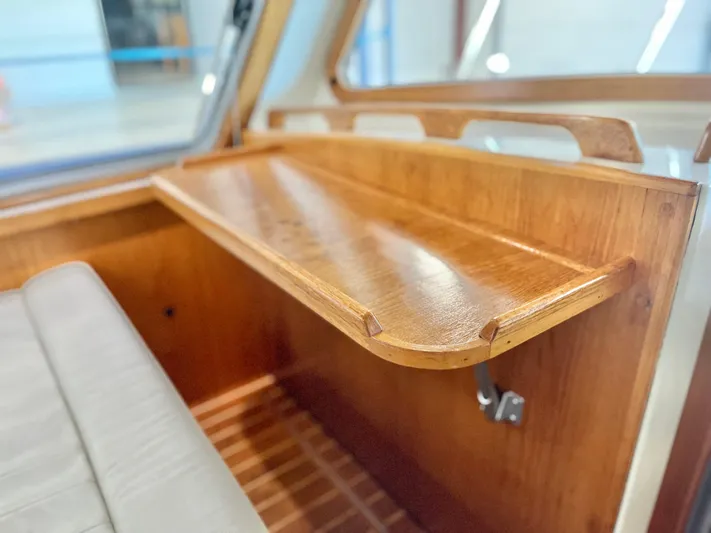  Yacht Photos Pics Wooden interior detail of a 2007 Coastal Craft 36 Cruiser boat, featuring a foldable table.