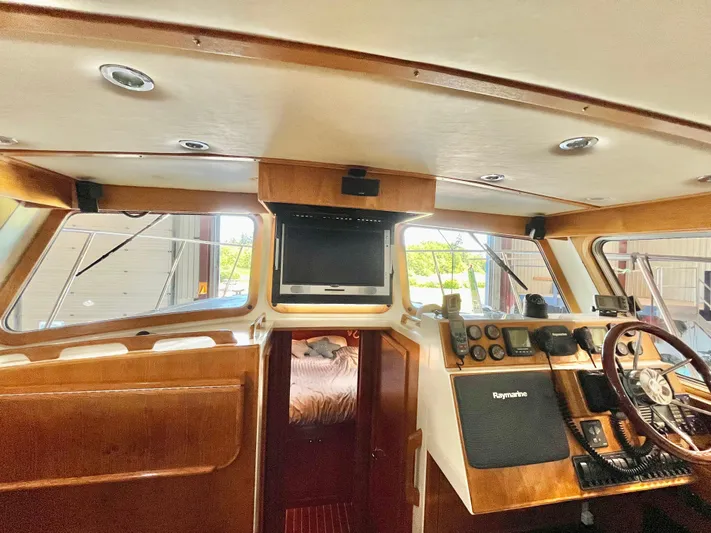  Yacht Photos Pics 2007 Coastal Craft 36 Cruiser interior with helm, wood finish, and navigation equipment.