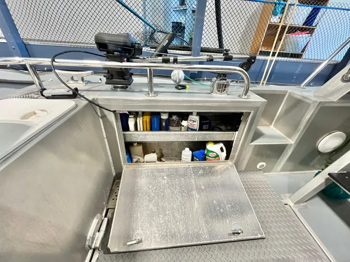  Yacht Photos Pics 2007 Coastal Craft 36 Cruiser storage area with open cabinet displaying various maintenance supplies.