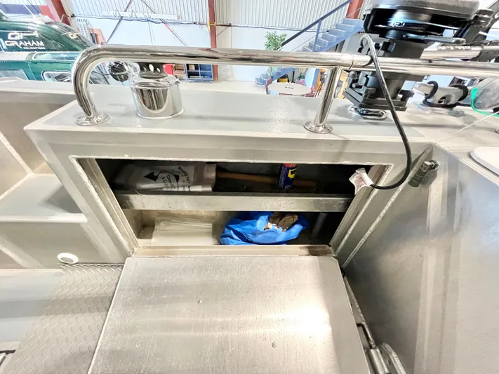  Yacht Photos Pics Storage compartment on a 2007 Coastal Craft 36 Cruiser boat, featuring tools and supplies.