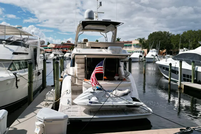 Incognito Yacht Photos Pics 2016 Sea Ray L590 Fly yacht docked at marina with American flag.