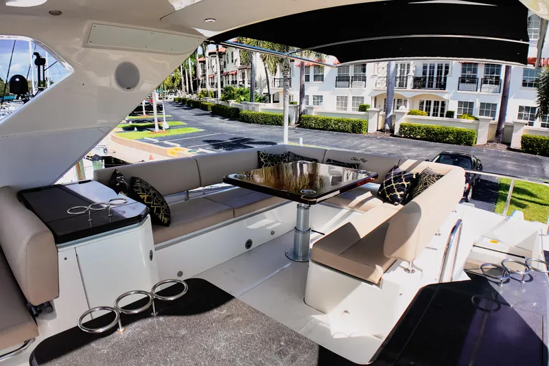 Incognito Yacht Photos Pics Luxurious 2016 Sea Ray L590 Fly yacht with elegant outdoor seating and dining area.