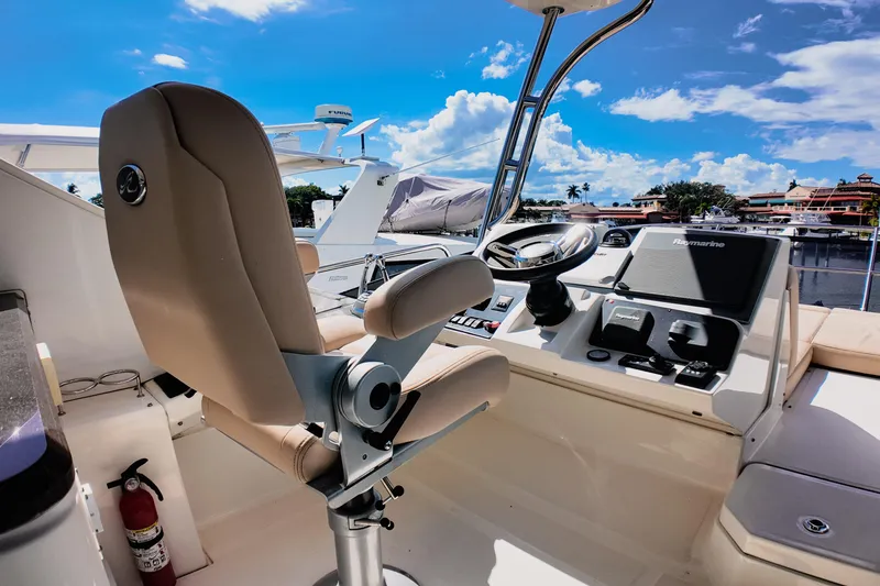 Incognito Yacht Photos Pics Flybridge helm of 2016 Sea Ray L590 Fly yacht with steering wheel and navigation controls.