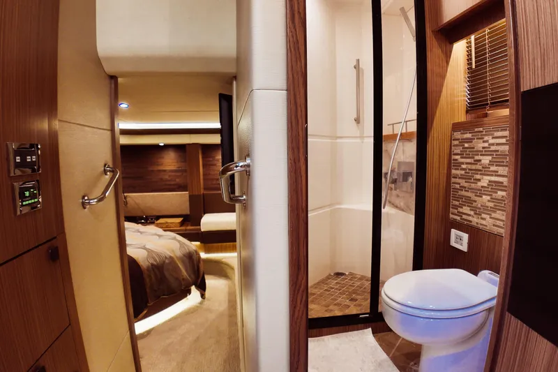 Incognito Yacht Photos Pics Luxurious interior of 2016 Sea Ray L590 Fly yacht featuring bedroom and bathroom.