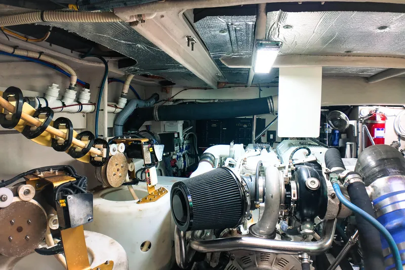 Incognito Yacht Photos Pics Engine room of a 2016 Sea Ray L590 Fly yacht, showcasing mechanical components and systems.