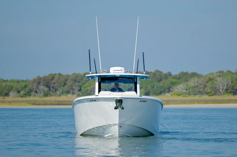  Yacht Photos Pics 2022 Solace 41 CS boat cruising on calm water with forested background.