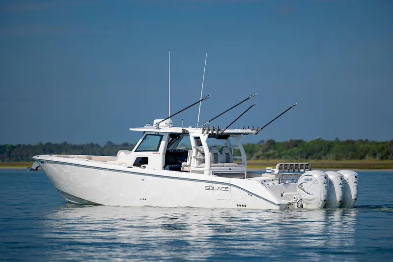  Yacht Photos Pics 2022 Solace 41 CS boat with triple Yamaha engines on calm water.