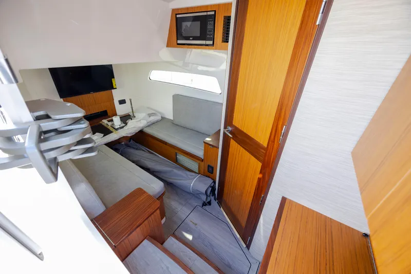  Yacht Photos Pics Interior of 2022 Solace 41 CS boat with modern wood finishes and seating area.