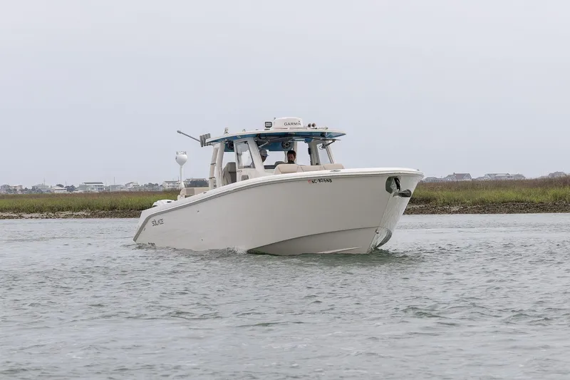  Yacht Photos Pics 2022 Solace 41 CS boat cruising on calm water near grassy shoreline.