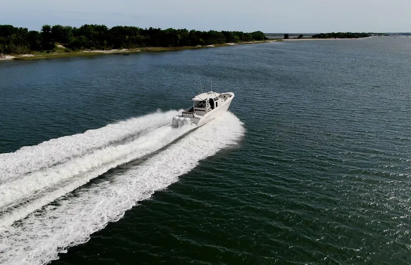  Yacht Photos Pics 2022 Solace 41 CS boat cruising on open water, leaving a wake behind.