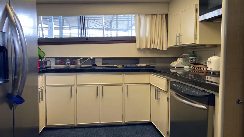  Yacht Photos Pics 1987 Hatteras 58 Motor Yacht kitchen with modern appliances and sleek cabinetry.