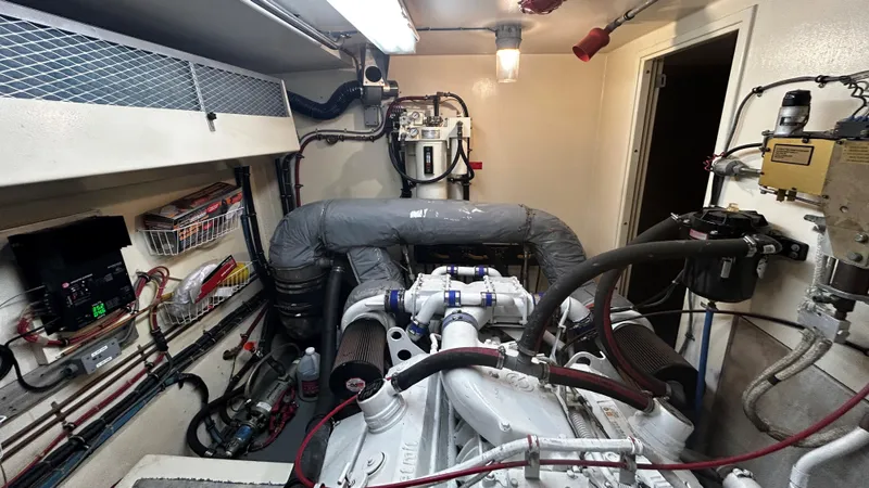  Yacht Photos Pics Engine room of a 1987 Hatteras 58 Motor Yacht, showcasing mechanical components and wiring.
