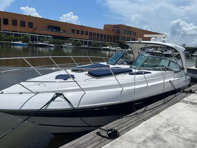 Alacrity Yacht Photos Pics 2008 Doral Mediterra yacht docked at marina, sleek design, sunny day, modern architecture in background.
