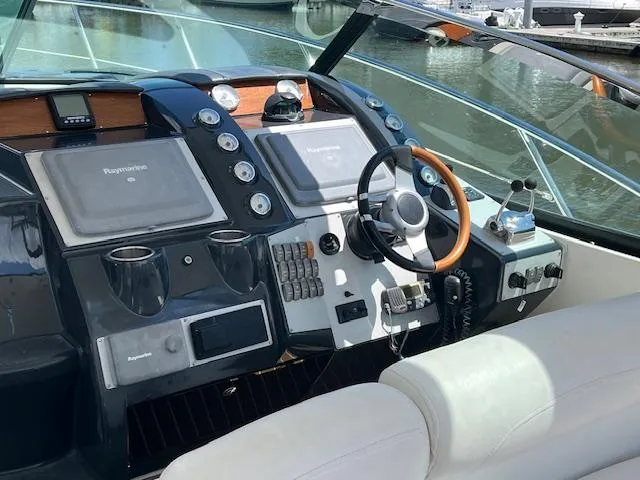 Alacrity Yacht Photos Pics 2008 Doral Mediterra boat dashboard with steering wheel and navigation controls.