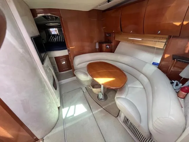 Alacrity Yacht Photos Pics 2008 Doral Mediterra yacht interior with curved seating, wooden table, and modern design.