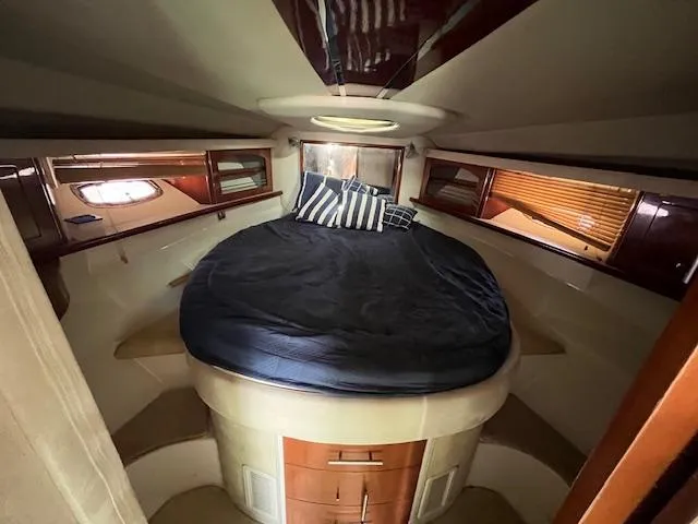 Alacrity Yacht Photos Pics Luxurious cabin interior of 2008 Doral Mediterra yacht with cozy bed and elegant wood finish.