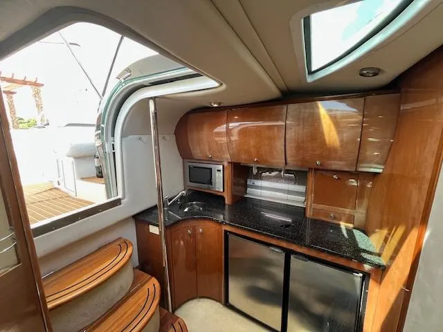 Alacrity Yacht Photos Pics Luxurious 2008 Doral Mediterra yacht interior with modern kitchen and wooden cabinetry.