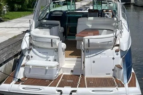 Alacrity Yacht Photos Pics 2008 Doral Mediterra boat with spacious deck and seating, docked by a canal.