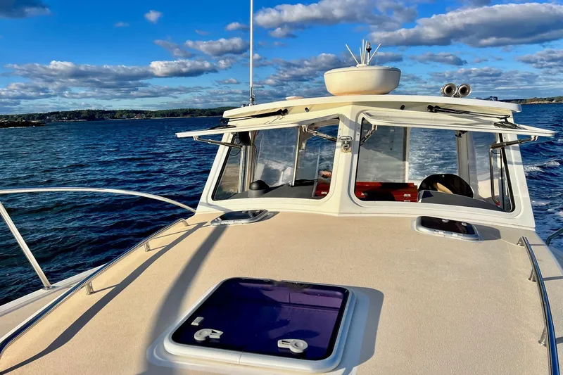 By The Way Yacht Photos Pics 2015 MJM 36z Express cruising on a sunny day with blue skies and calm waters.